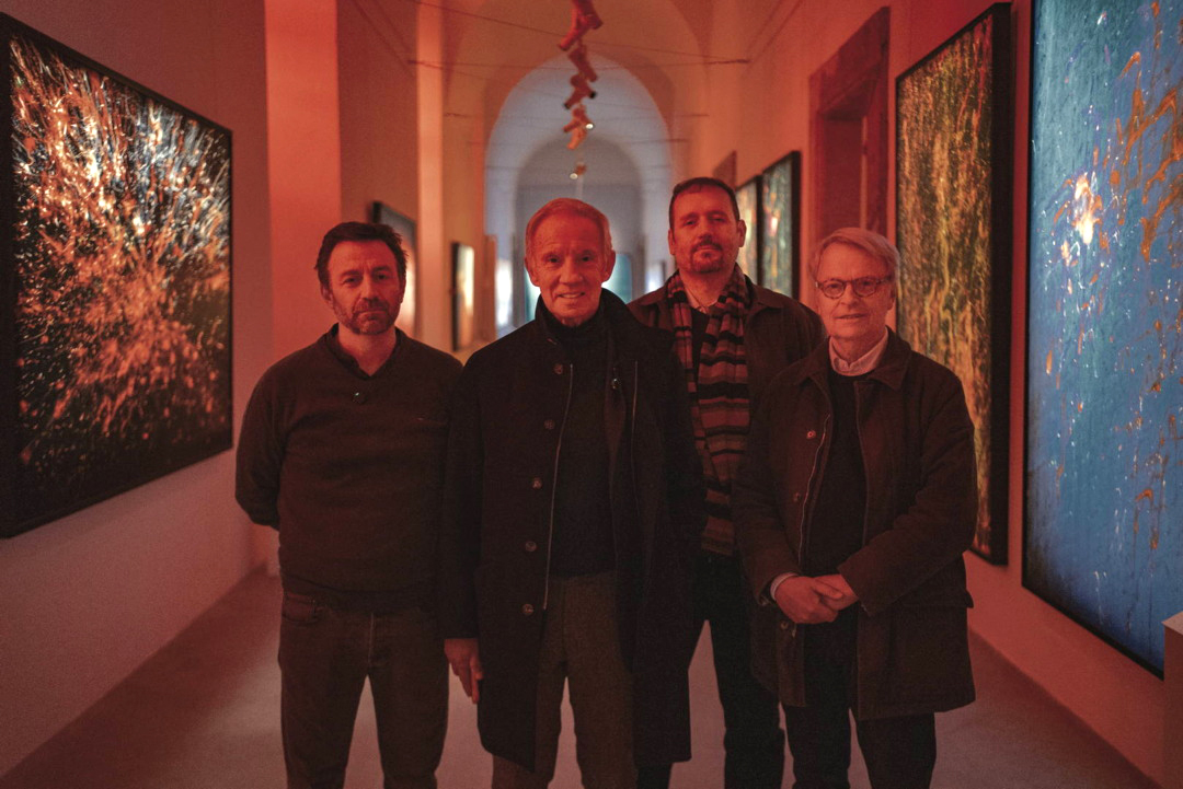 Uno scatto che ritrae l'autore della mostra insieme al curatore e alcuni critici d'arte cricondati dalle fine art print e lightbox fine art realizzati dal nostro laboratorio fotografico